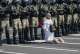 Woman stands on her knees in front of militaries during the beginning of one of the Sunday marches. August 30, 2020. | Tanya Kapitonova, 2020
